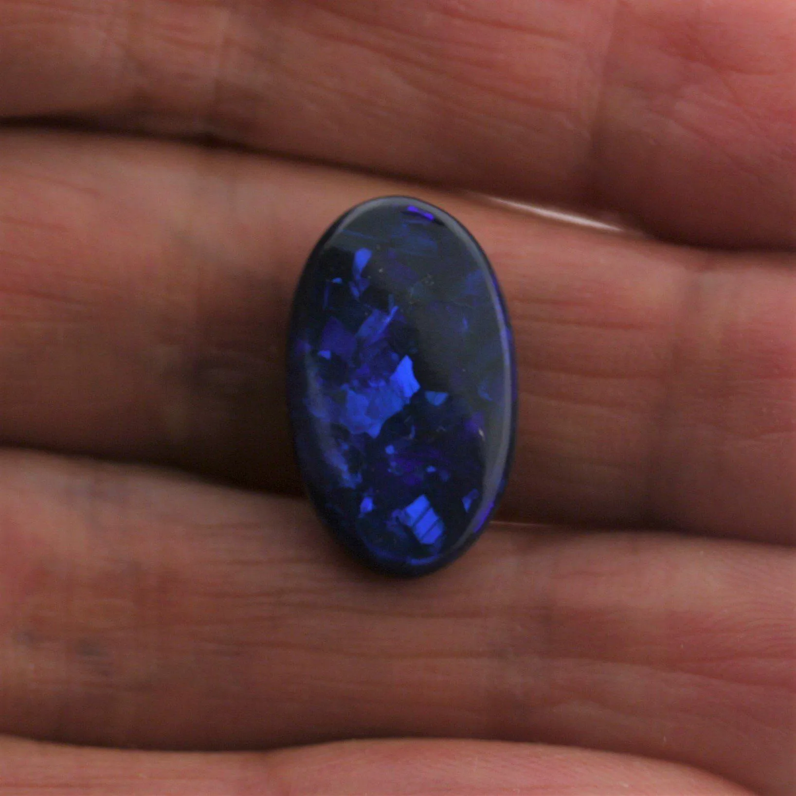 5.44 carat Black Opal Oval Flat Cabochon Blue Play of color