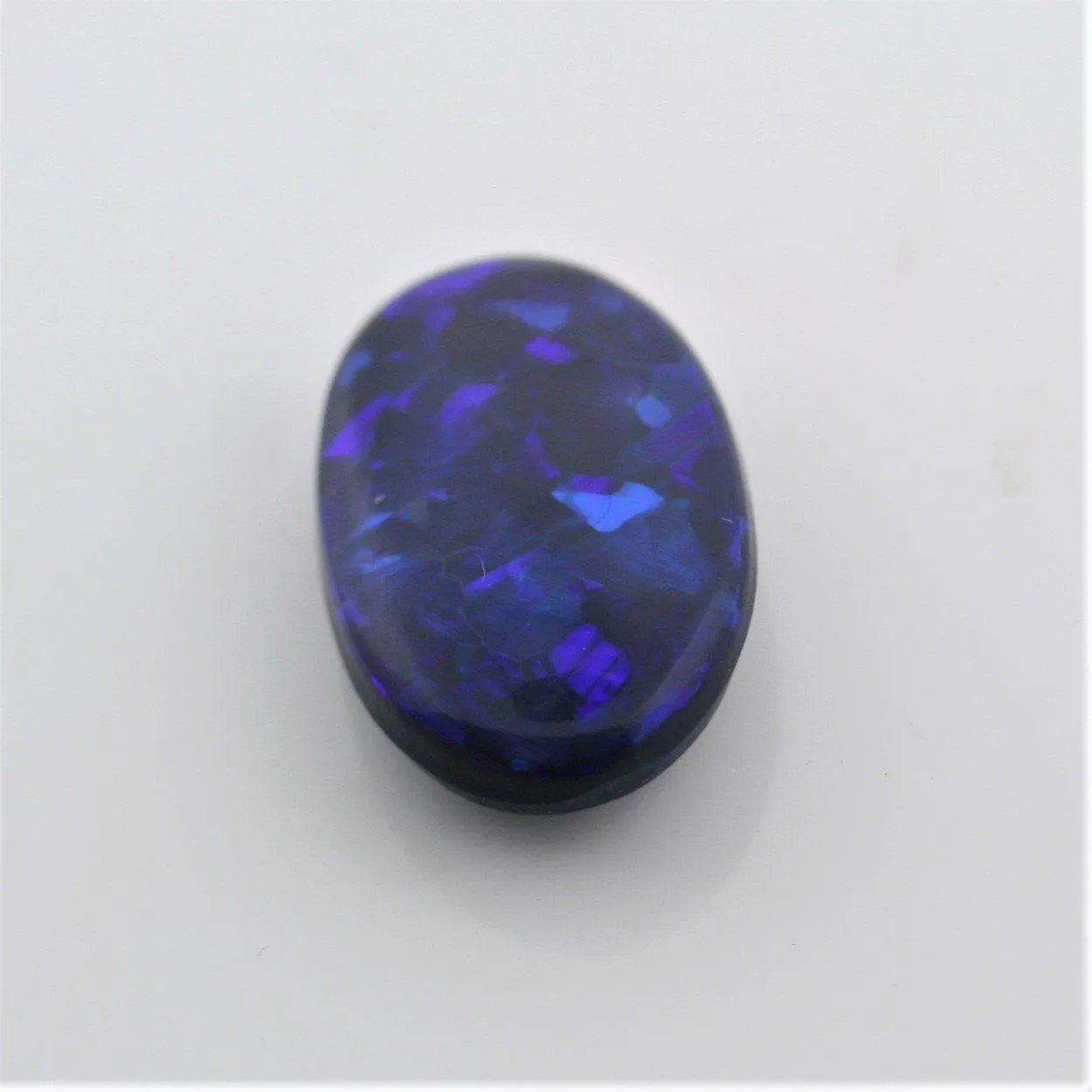 5.44 carat Black Opal Oval Flat Cabochon Blue Play of color